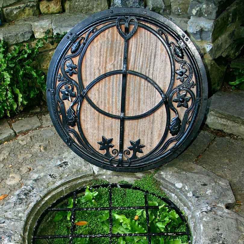 The Chalice Well lid at Glastonbury — two interlocking circles forming a Vesica Piscis in ornate ironwork