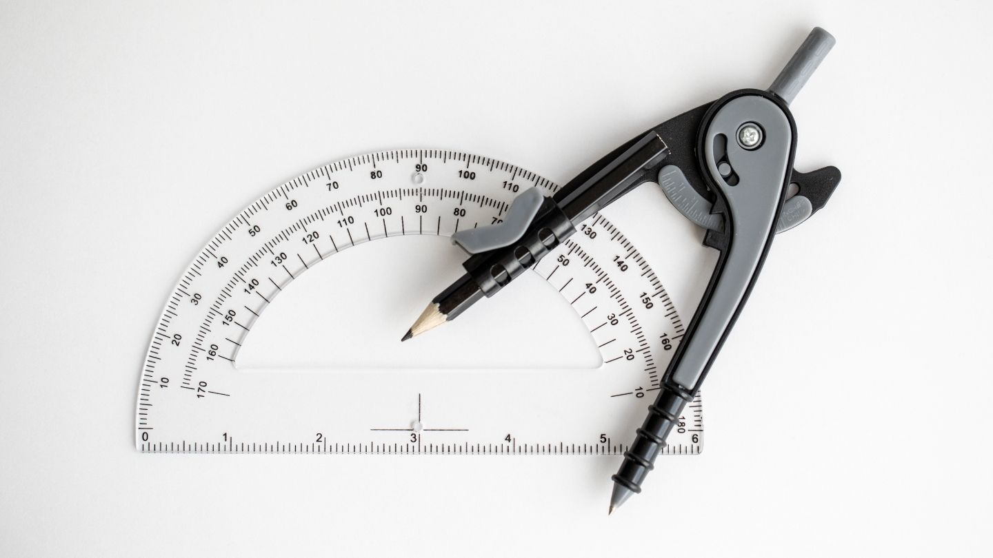 A real drawing compass and protractor — the tools of geometric construction