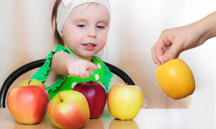A child counting objects on a table